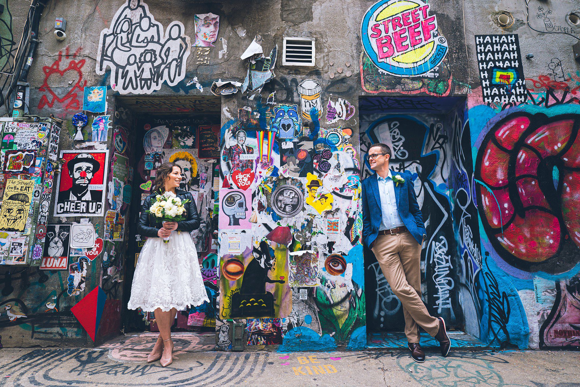 Bride and Groom posing in front of a Graffiti Wall by Sascha Reinking Photography, New York Elopement Photographer