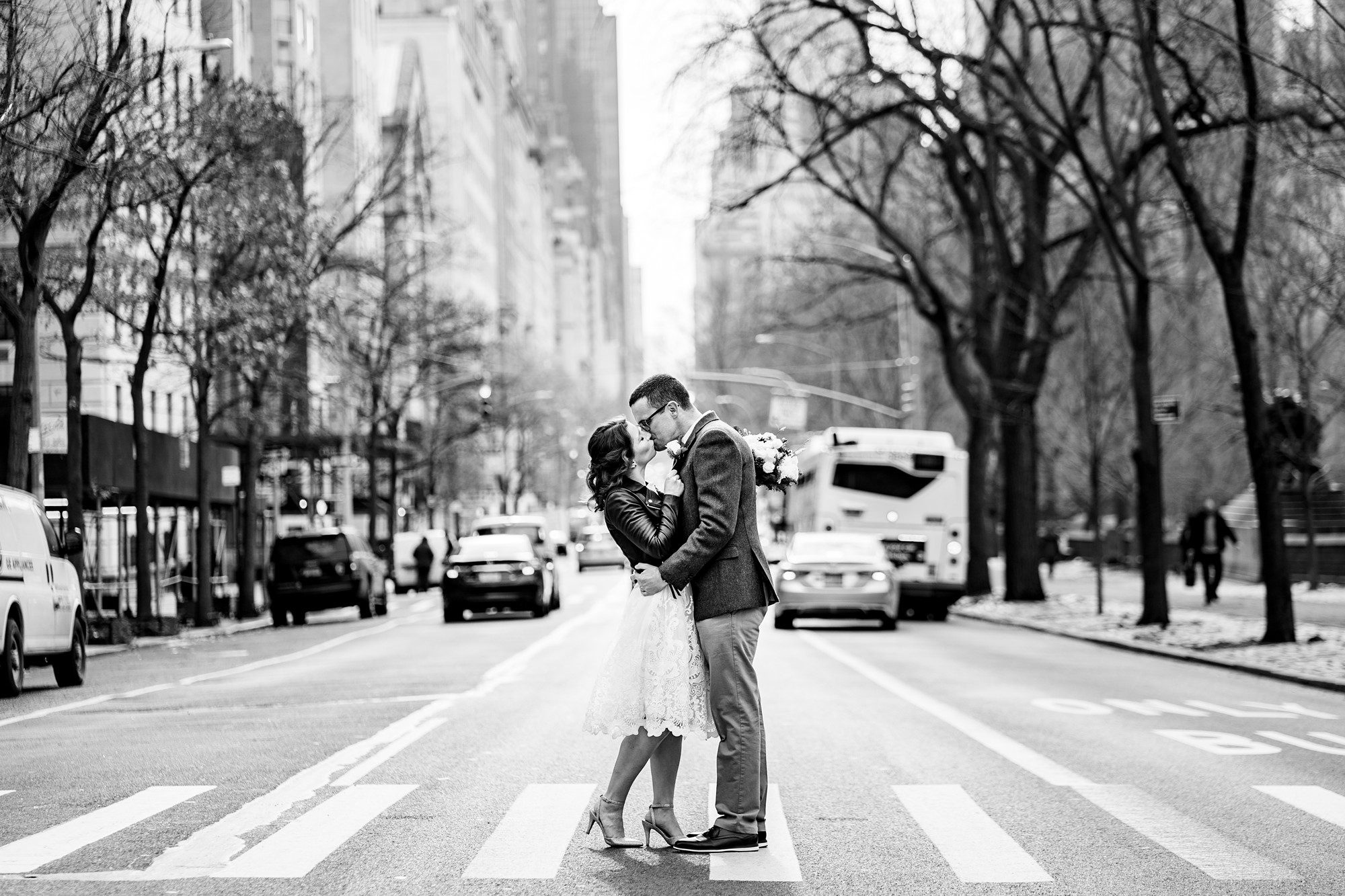 Happy wedding couple in the middle of a New York City crosswalk by Sascha Reinking Photography, New York Elopement Photographer