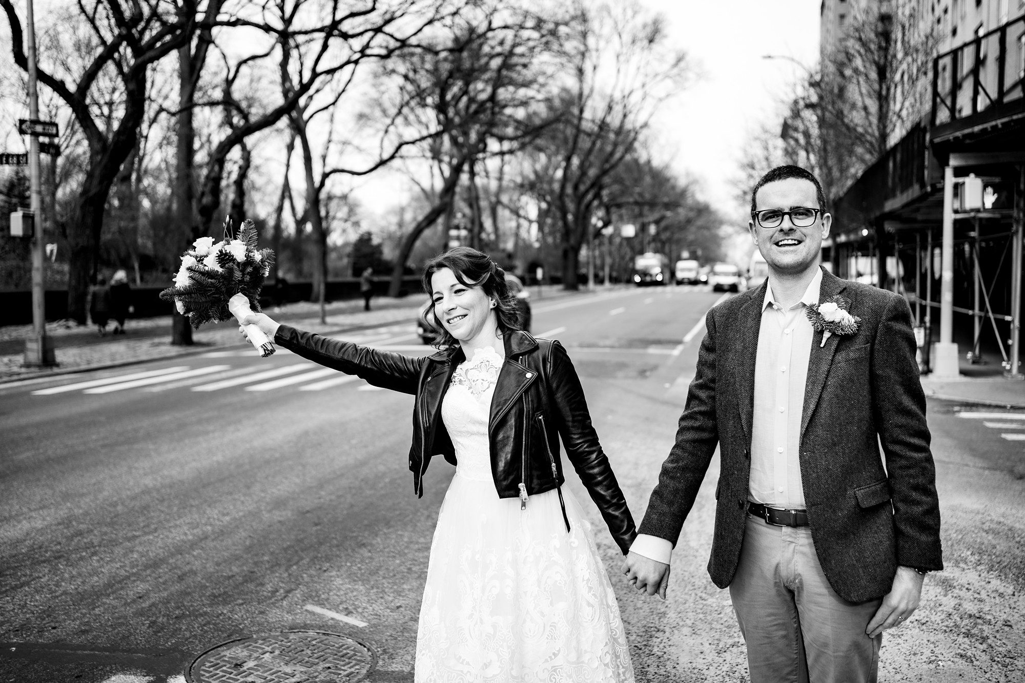 Happy newlywed couples hailing a taxi cab in NYC by Sascha Reinking Photography, New York Elopement Photographer